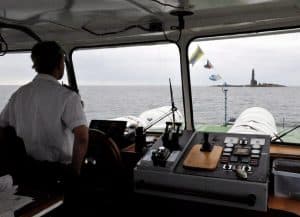 epa01796123 The captain of a ship watches as the lighthouse of Bengtskaer island appears, 25km off the southern Finnish coast, 04 July 2009. Bengtskaer is the southernmost inhabited Finnish island. Scandinavia's highest lighthouse (52 meters above the sea) was built on the island in 1906 after numerous shipwrecks prompted the authorities to secure the seaway. The lighthouse suffered damage in both world wars and was the scene of fierce fighting between Finnish and Soviet troops in 1941. The granite rock islet is only some two hectares large, with very little fauna and plants and is visited by thousands of tourists yearly. The buildings on the island belong to Turku University since 2000 and serve as tourist, conference, research and education center that also offer accomodation and food. The historic lighttower with its 252 steps can be climbed by visitors.  EPA/MAURITZ ANTIN